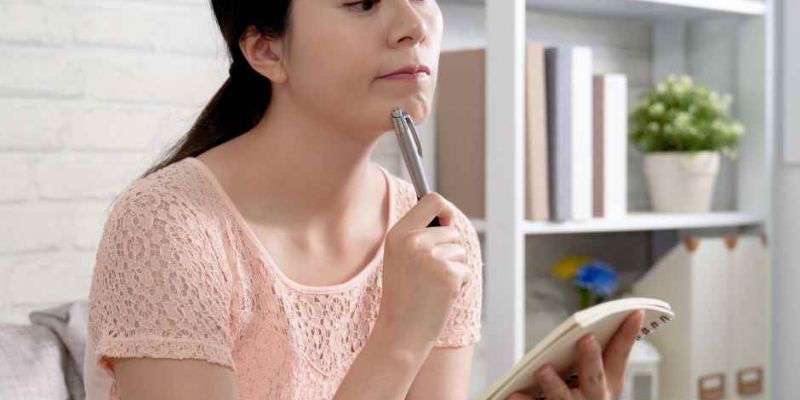 Woman looking overwhelmed by her to-do list.