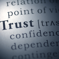 Close up of the word Trust in a dictionary.
